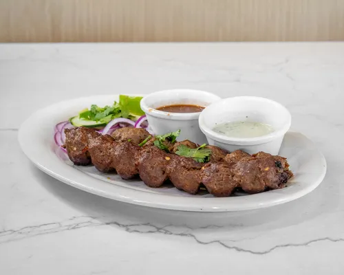 Beef seekh kabab with onions, cucumber and sauces